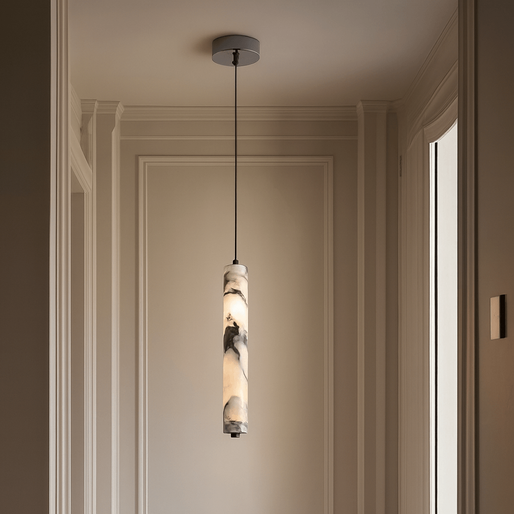 Pendant light fixture hanging in a room with neutral walls and trim.