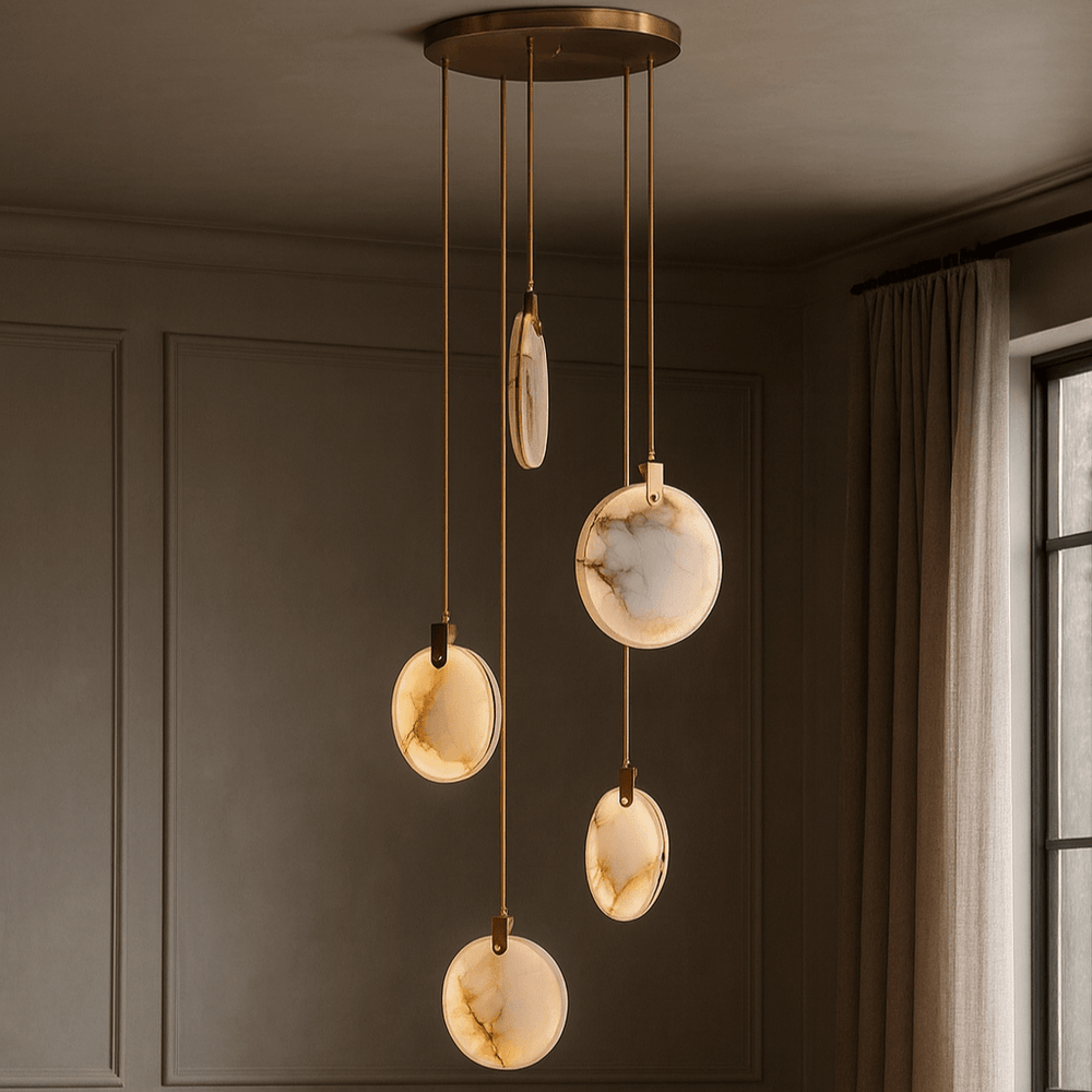 
                  
                    The Moonshade 5-Pendant Marble Chandelier by Morsale.com features five marble-like pendants at varying heights from a gold mount, creating a sculptural LED statement that pairs beautifully with gray paneled walls and beige curtains.
                  
                