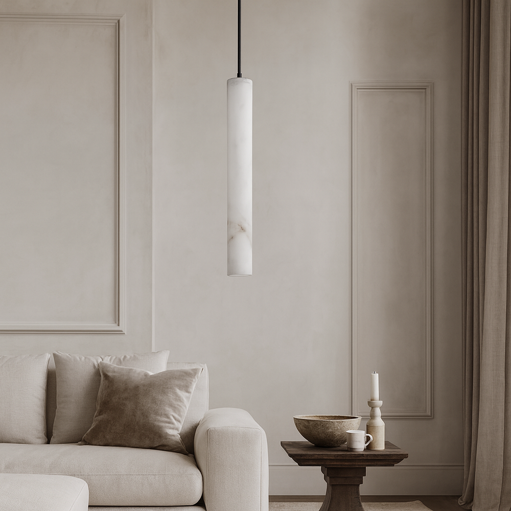 
                  
                    A minimalist living room featuring a beige sofa and cushion, small wooden side table with bowl, mug, candle, tall beige curtains, paneled walls, and the Morsale Moonshade Natural Marble LED Pendant for subtle elegance.
                  
                