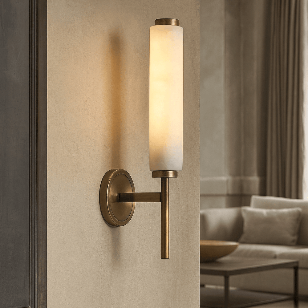The Burston Marble Wall Sconce by Morsale.com, featuring a cylindrical frosted glass shade, is mounted on a light wall in an elegant living room, adding a refined and modern touch to the space.