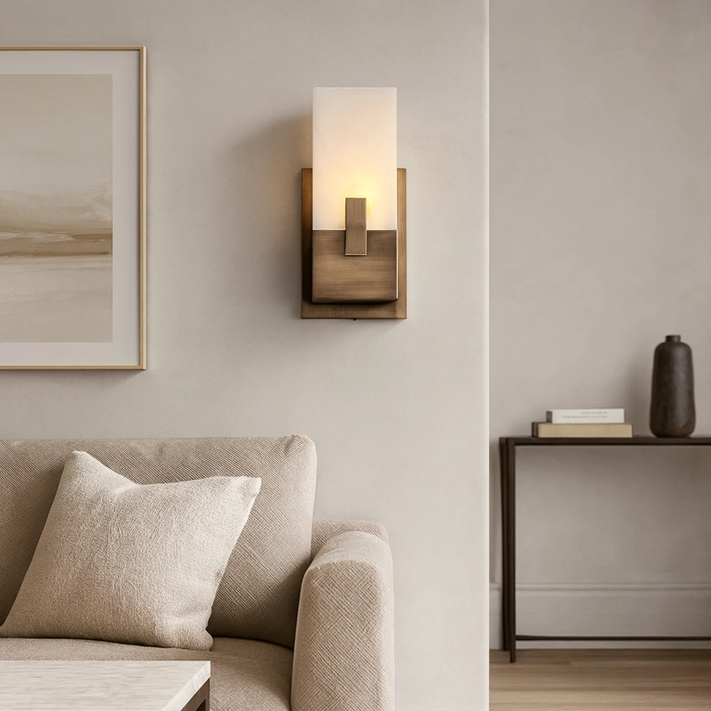 Modern wall sconce in a living room setting with a sofa and framed artwork.