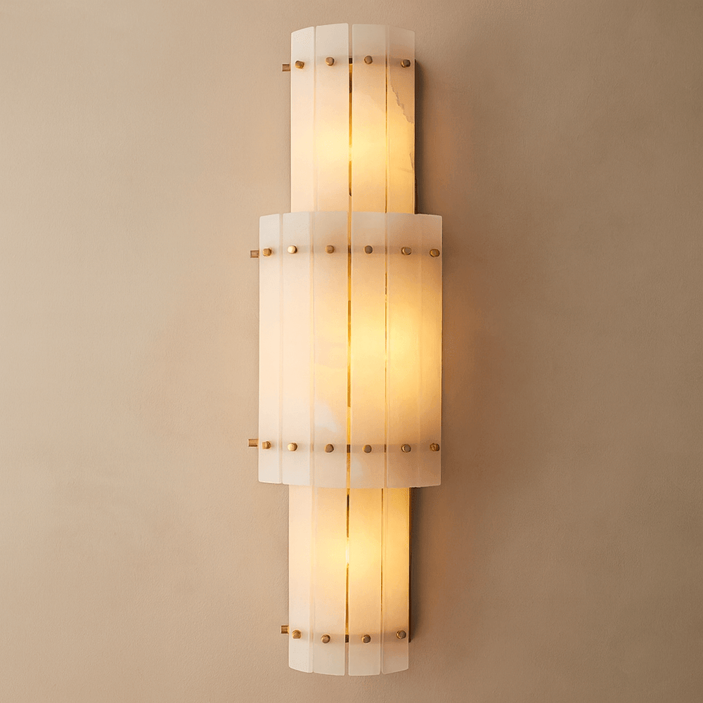 
                  
                    The Valmont Marble Wall Sconce by Morsale features three curved white panels, brass accents, and a warm glow, adding modern luxury and elegance to any beige wall.
                  
                