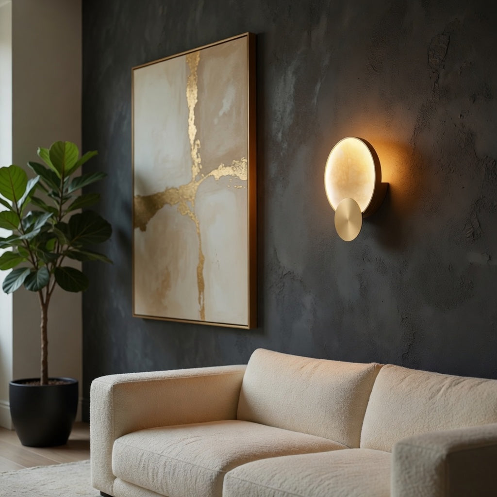 Modern living room with a beige sofa, abstract painting, and wall sconce.