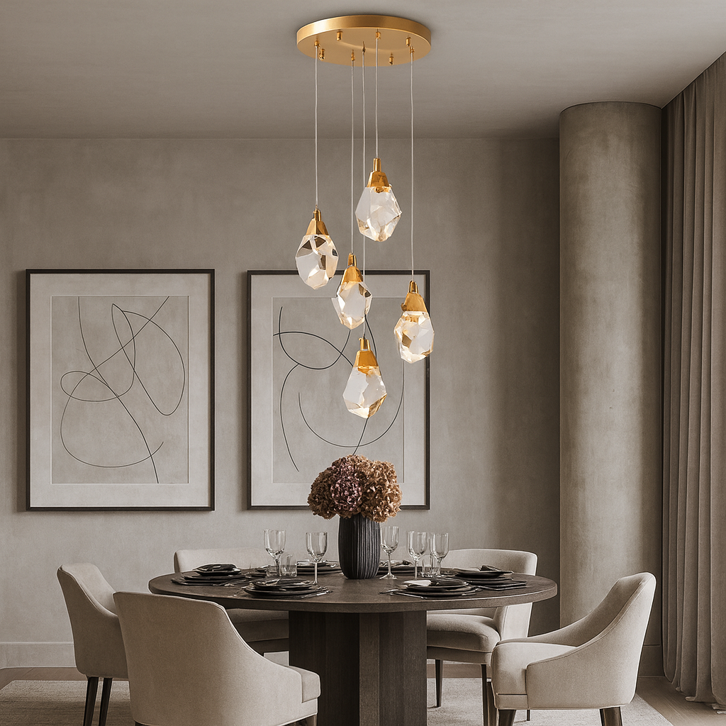 A modern dining room features a round table, four upholstered chairs, abstract art, and the Diamante Crystal Chandelier by Morsale.com above a dried flower centerpiece. Neutral tones and dimmable LED lighting complete the elegant, minimalist look.