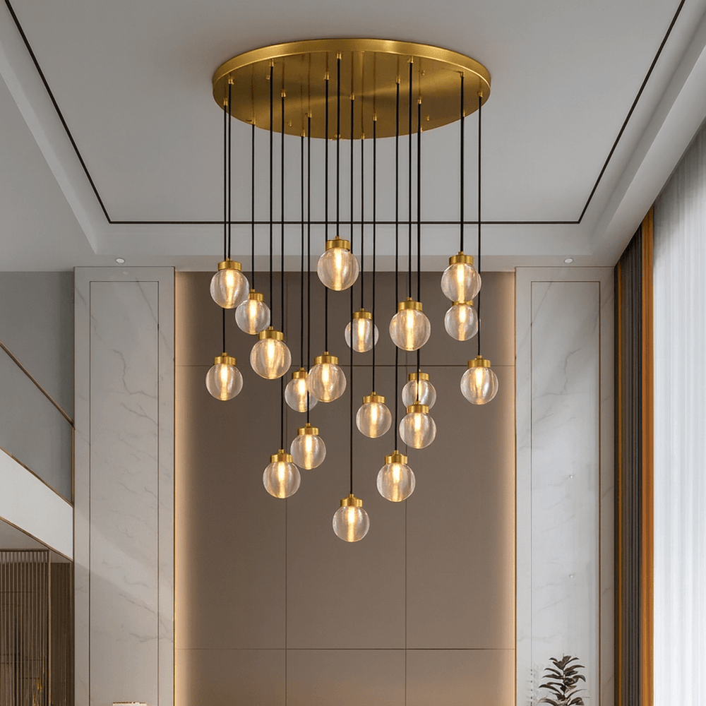 The Morsale Bossen 19-Globe Modern Chandelier, featuring multiple glass globe pendants, hangs in a sleek, contemporary room with neutral tones and large windows.