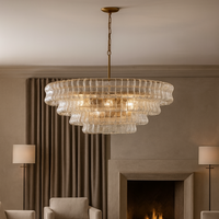 Luxurious living room with a chandelier, sofa, coffee table, and fireplace.