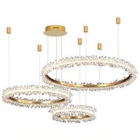 The Capri 3-Ring Crystal Chandelier by Morsale.com showcases three gold hoops of varying sizes, suspended from a gold ceiling mount. This luxurious and elegant lighting fixture is adorned with crystal accents and incorporates LED lighting, crafted from high-quality materials.