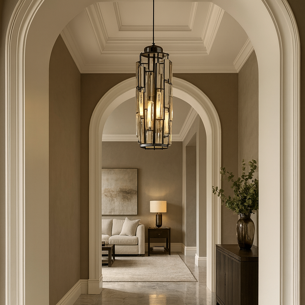 
                  
                    A hallway with arched doorways, beige walls, and the Astoria Crystal Cage Pendant by Morsale.com leads to a living area featuring a sofa, side table, lamp, wall art, and a vase with greenery on a cabinet. The space is elegant and softly lit.
                  
                
