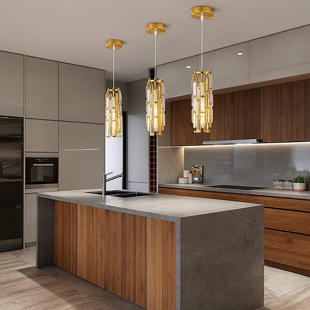 A modern kitchen features a wooden island, gray countertop, built-in appliances, and three Morsale.com Astoria Crystal Cage Pendants illuminating the space. Cabinets combine wood and glossy gray finishes.