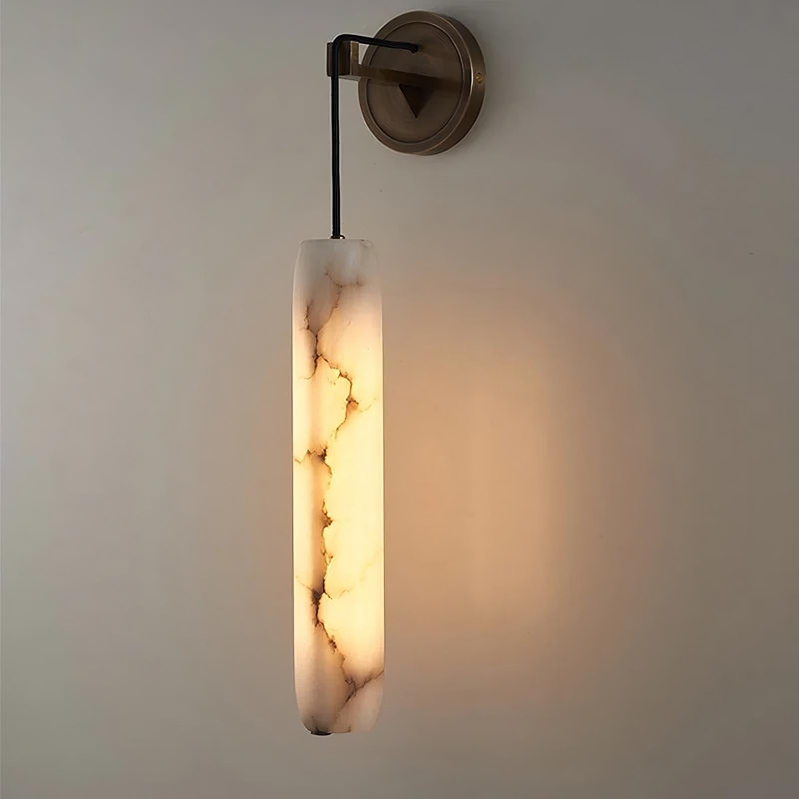 Introducing the Moonshade Natural Marble Pendant Wall Sconce from Morsale.com. This contemporary fixture features a cylindrical shade with a natural marble pattern, exuding an elegant ambiance with its warm glow. It's mounted on a circular brass base, perfect for adding sophistication to any plain wall.