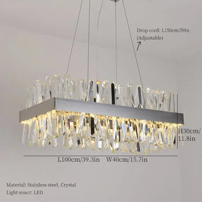 The Calvi Crystal Dining Room Light Fixture from Morsale.com features a modern rectangular chandelier with a stainless steel frame and multiple K9 crystal prisms, hanging elegantly from three adjustable drop cords. The dimensions are: drop cord length is 150 cm/59 in, fixture length is 100 cm/39.3 in, width is 40 cm/15.7 in, and height is 30 cm/11.8 in. The light source utilizes LED technology.