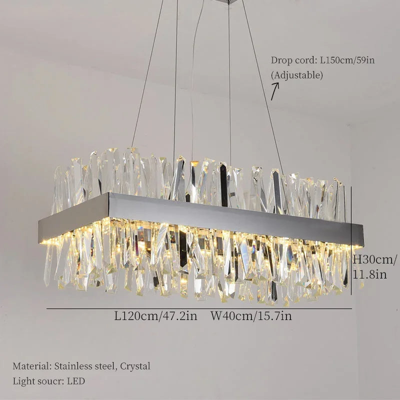 The Calvi Crystal Dining Room Light Fixture from Morsale.com is a modern rectangular LED ceiling chandelier with handmade crystal accents. It is suspended from the ceiling by adjustable steel cords, with dimensions of 120cm in width, 40cm in depth, and 30cm in height. Made of stainless steel and crystal, this elegant design features a drop cord length that can be adjusted up to 150cm.