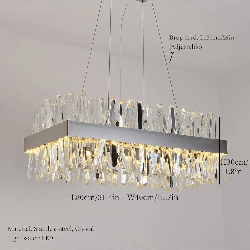 Experience the elegant design of the Calvi Crystal Dining Room Light Fixture by Morsale.com, a modern rectangular ceiling chandelier featuring a stainless steel frame and handmade crystal accents. Dimensions: L80cm x W40cm x H30cm, with an adjustable drop cord length of 150cm. The light source is LED.