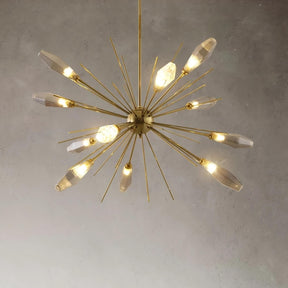 A modern, sophisticated lighting fixture, the Morelli Sputnik Chandelier by Morsale.com features gold metallic rods extending in all directions, each ending in light bulbs encased in sleek, translucent covers. It is set against a plain, light-colored wall with a small wooden bowl on a table beneath it.