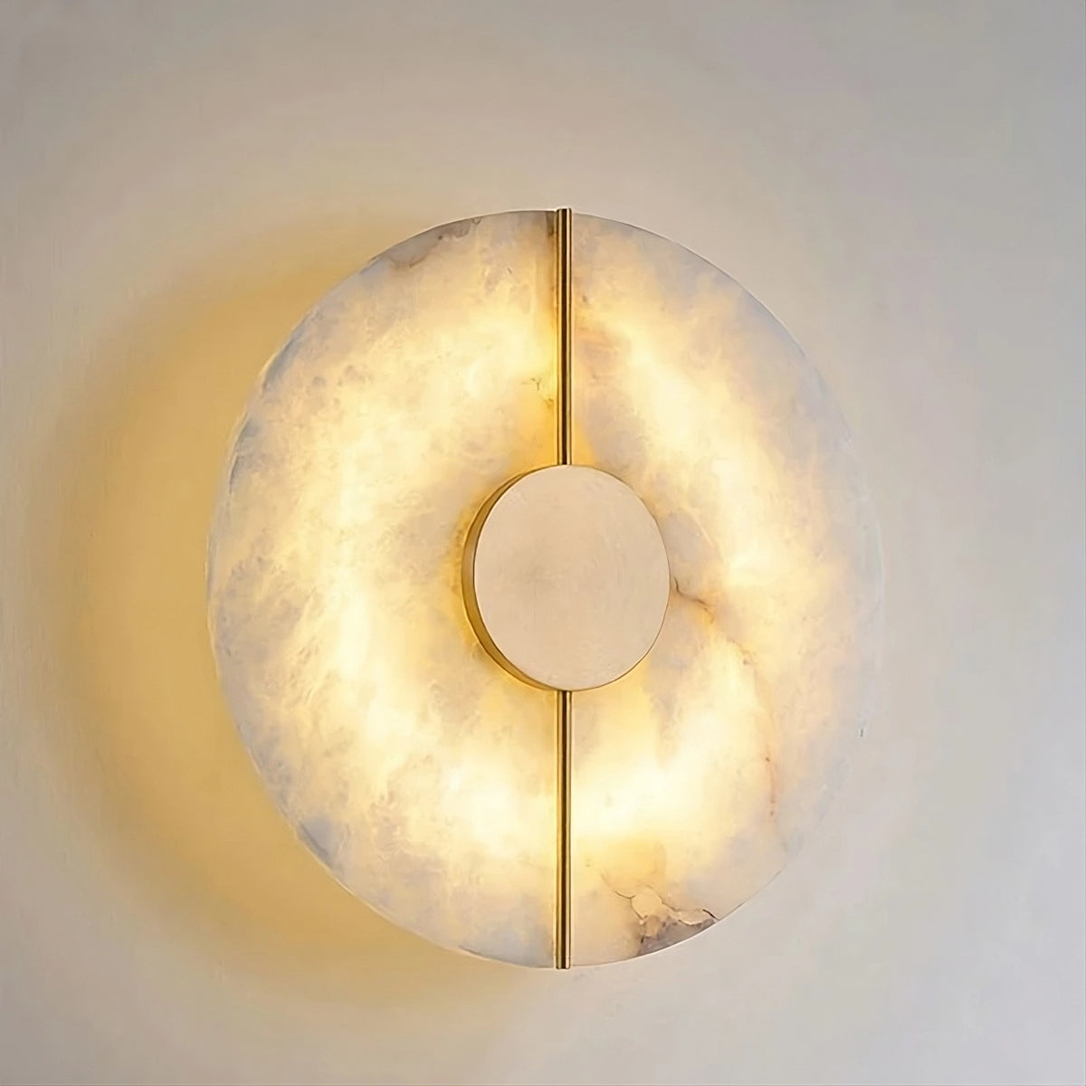 The Moonshade Natural Marble & Copper Wall Sconce by Morsale is a circular LED wall lamp with a marble pattern that emits a soft, warm glow. Its modern design includes a central circular disc and a vertical dividing line, making it an elegant lighting piece for any plain wall.