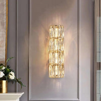 Bacci Modern Crystal Wall Sconce illuminating a modern wall with elegant crystal design.