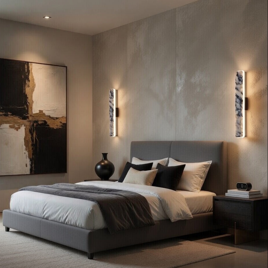 Modern bedroom with a bed, nightstands, and wall art in a neutral color scheme.