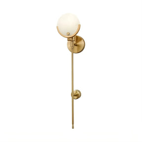 Introducing the Natural Marble Wall Light Sconce by Morsale.com: A modern wall-mounted light fixture featuring a gold finish and sleek design. The round frosted glass globe at the top, coupled with a thin, elongated stem with a smaller round support detail halfway down, brings elegance. Complemented by dimmable LED functionality for versatile lighting.