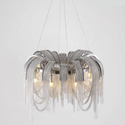 A modern chandelier with an intricate design featuring multiple draped chain elements in a metallic finish. This Cadena Chain Tassel Modern Chandelier from Morsale.com emits light from several E14 LED bulbs placed within the circular frame, creating a contemporary and elegant focal point. The adjustable ceiling wire length ensures a perfect fit for any space.