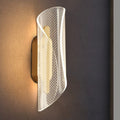 Lamina modern LED wall sconce with frosted acrylic diffuser in a living room
